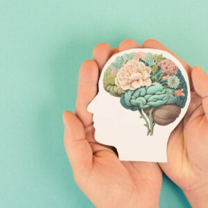 Hands holding paper head, human brain with flowers, self care and mental health concept, positive thinking, creative mind, generative AI used for brain Hands holding paper head, human brain with flowers, self care and mental health concept, positive thinking, creative mind, generative AI used for brain